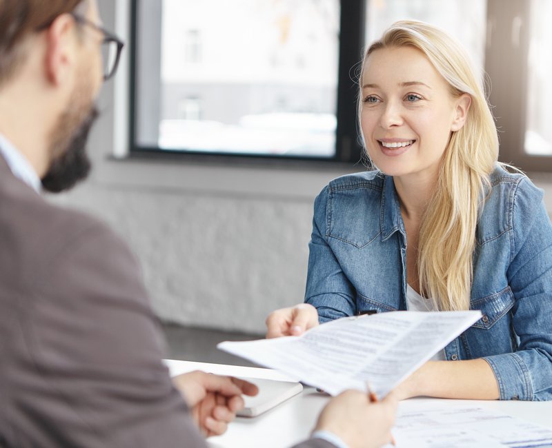 Portrait of successful business people work together with documents, develop common project, discuss enterneurship, meet in coworking process, have productive brainstroming session. Mutual partnership